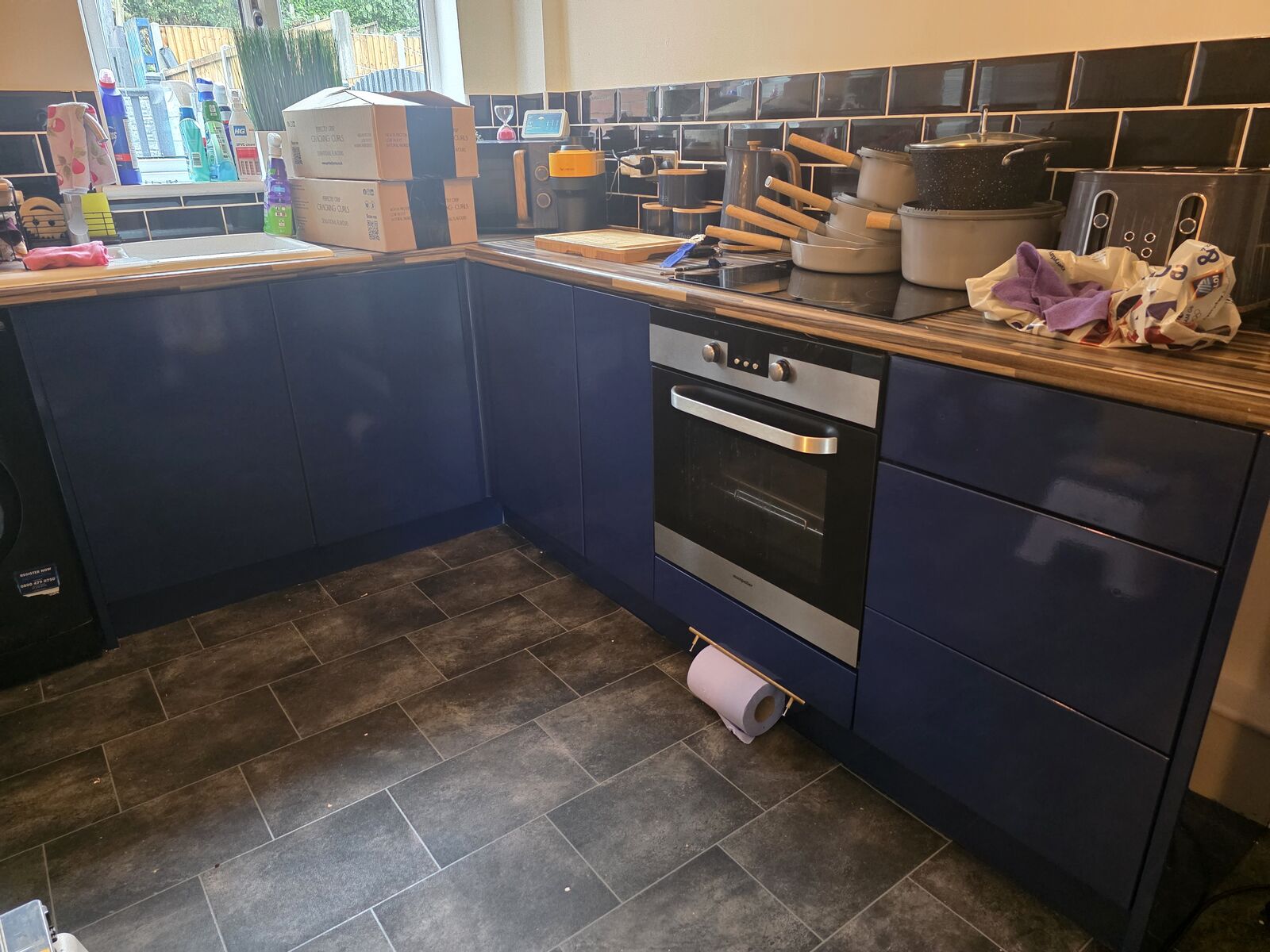 Kitchen units after wrapping in a navy gloss vinyl