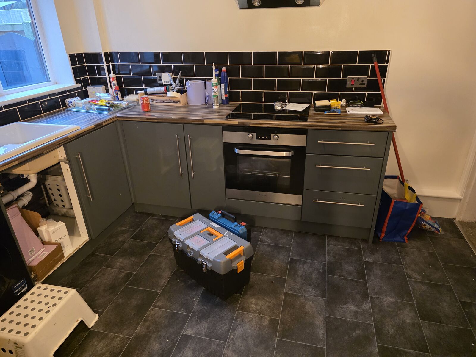 Grey kitchen units before vinyl wrapping