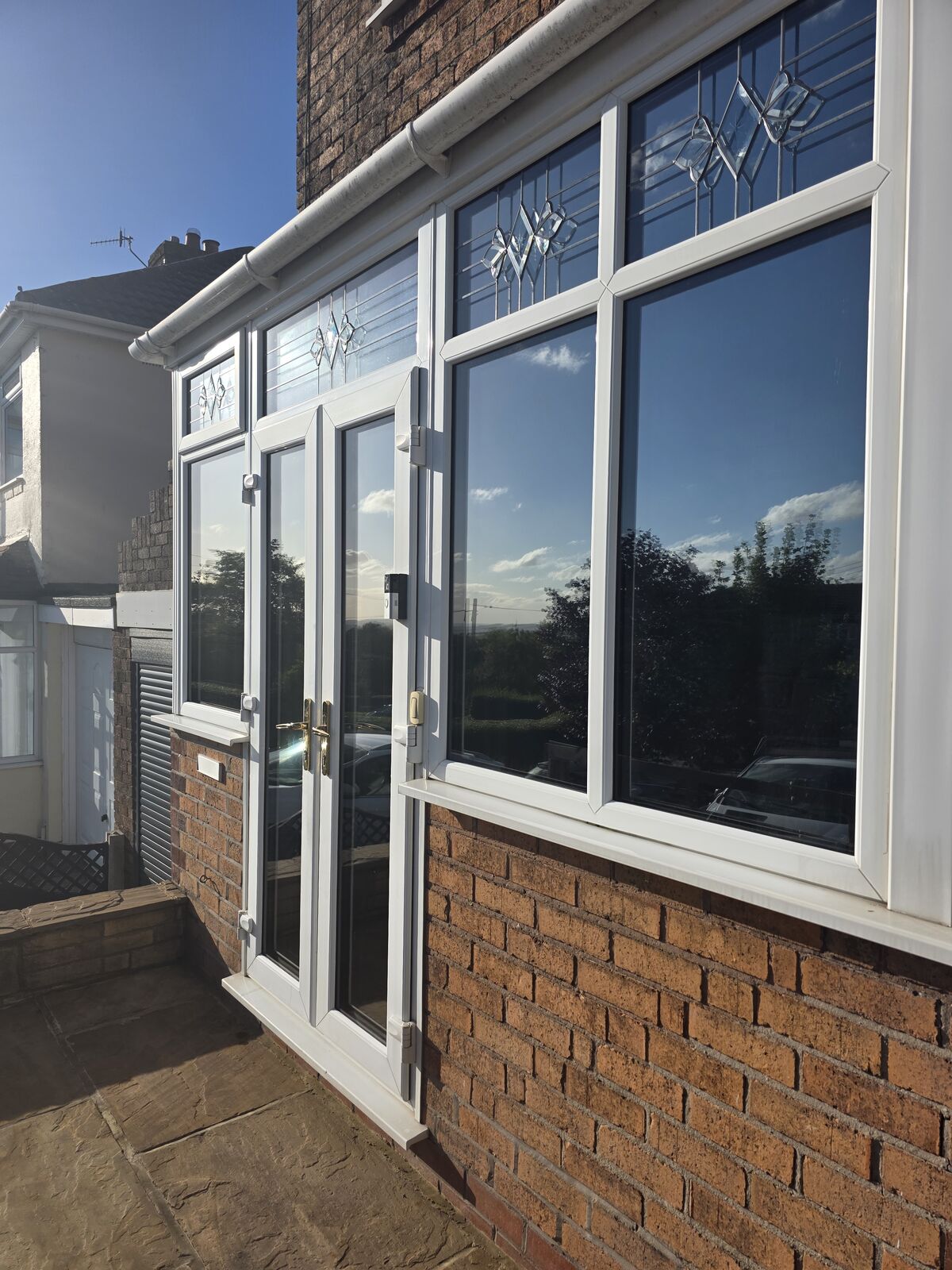 Porch windows after tint film was applied to the glass, giving a reflective privacy finish