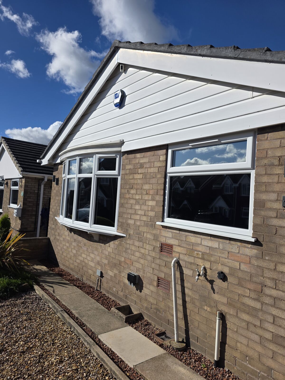 Bungalow front windows after privacy tint was applied to the glass